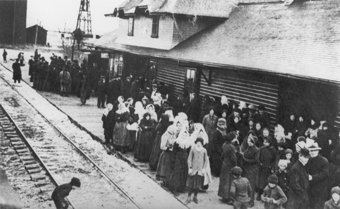 Mennonite families wait at train station to leave Canada